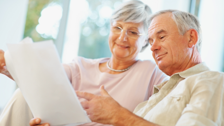 Image of an elderly couple carrying out some personal planning.