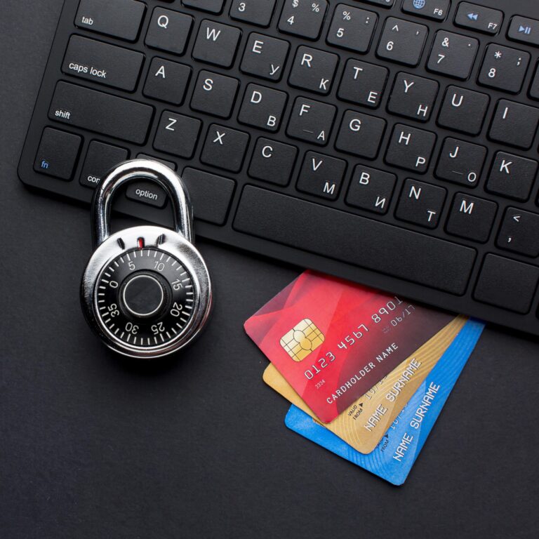 Image showing a padlock on credit cards, which are below a computer keyboard.