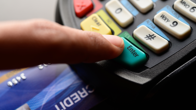 Index finger on credit card machine