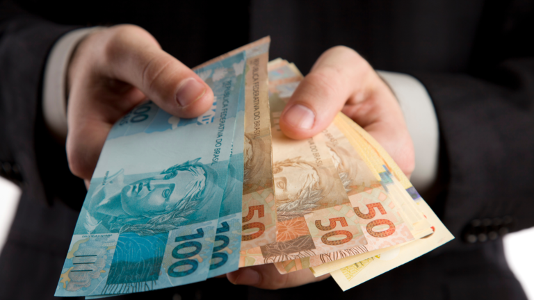 Image showing the bust of a person holding real banknotes.