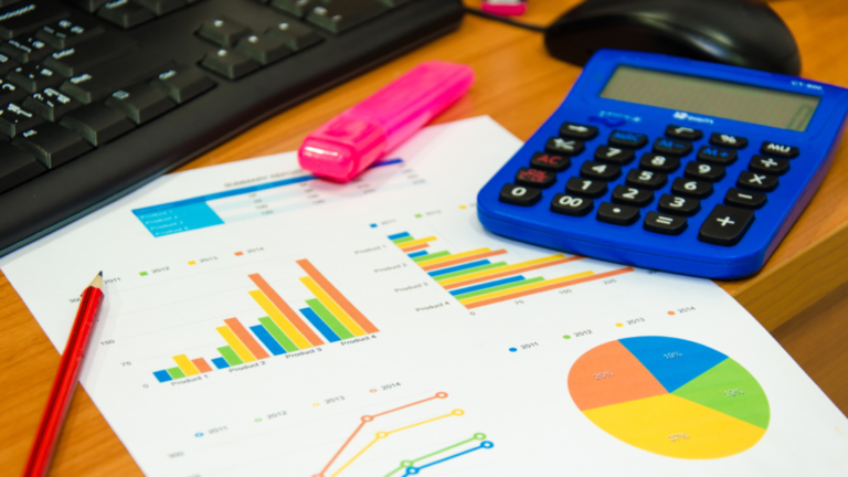 Image showing a computer keyboard, calculator and a sheet with financial calculations and graphs.